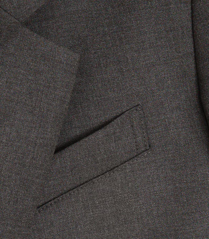 Close-up of a dark gray textured fabric with a diagonal welt pocket detail.
