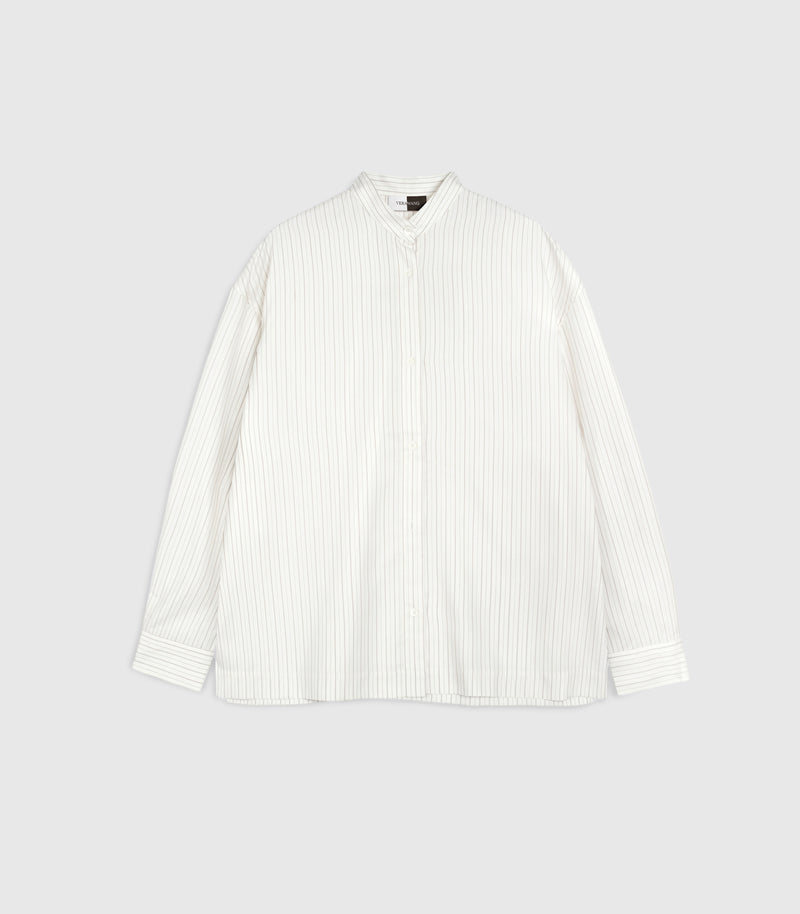 Flat lay product view of a relaxed-fit ivory boyfriend shirt featuring fine vertical pinstripes. The design showcases a structured band collar with a small top button, a full-length tonal button placket, dropped shoulder seams, and long sleeves with wide, buttoned cuffs, presented against a clean light grey backdrop.