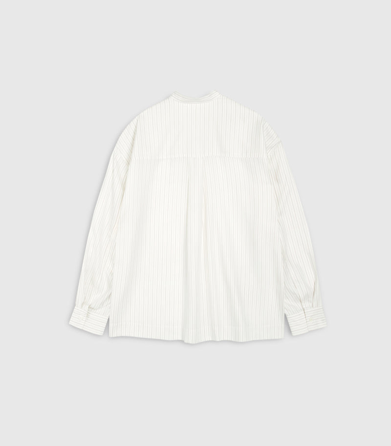 Flat lay rear view of a relaxed-fit ivory boyfriend shirt featuring fine vertical pinstripes. The design showcases a structured straight back yoke panel with a prominent centre-back box pleat, dropped shoulder seams, a clean band collar, and long sleeves with wide buttoned cuffs against a seamless light grey backdrop.