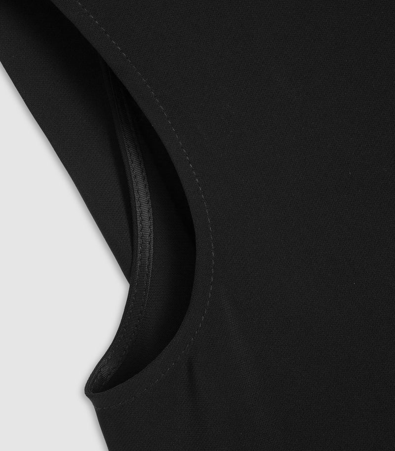 Close-up detail of a black sleeveless top or dress, showing the curved neckline and fine fabric texture against a light gray background.