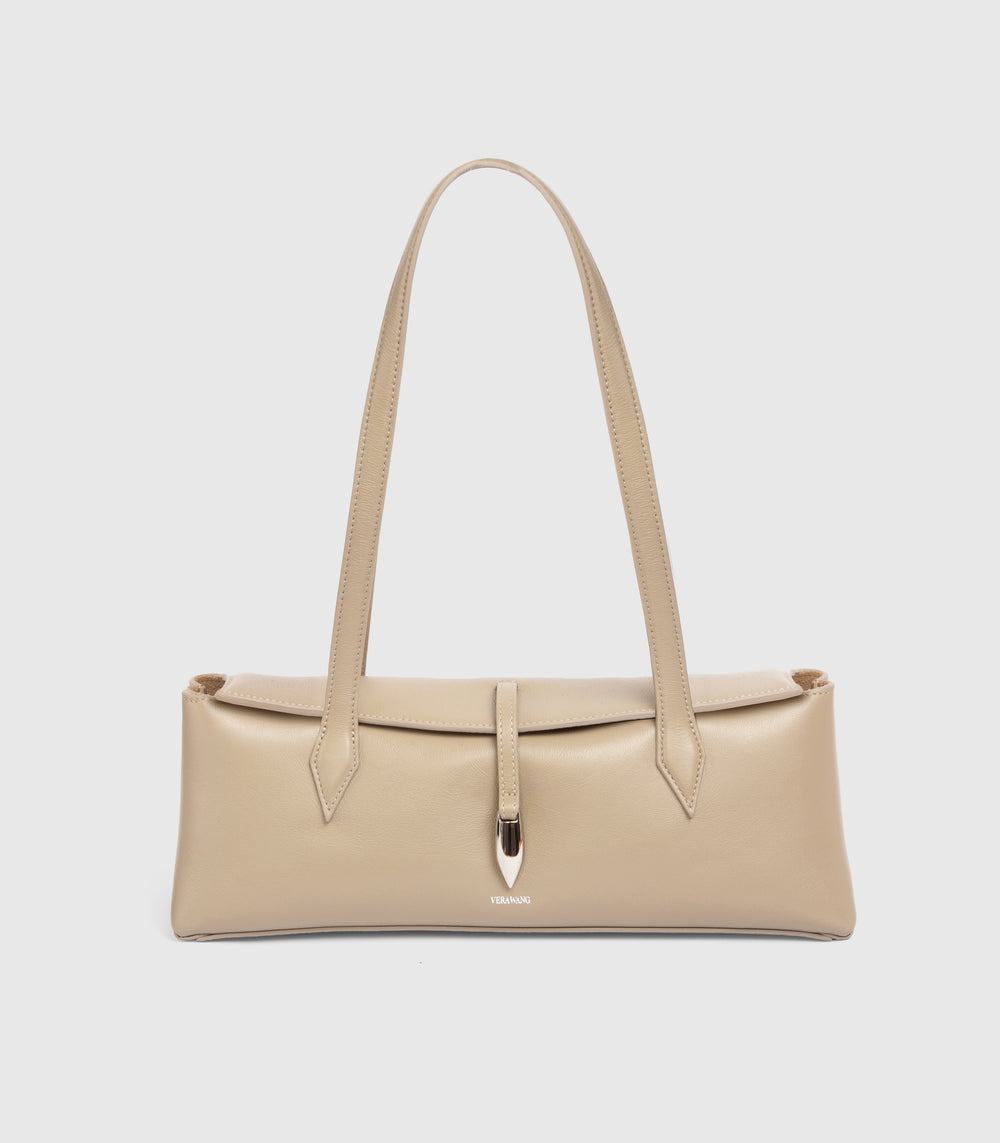 A structured beige leather shoulder bag with long double straps and a central strap detail secured by a metallic silver clasp, shown against a light gray background.
