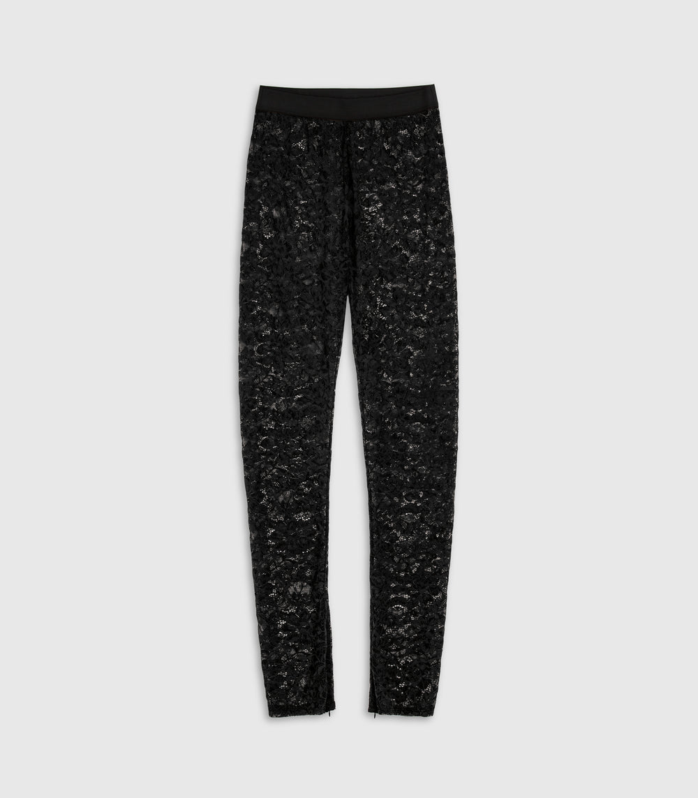 A front flat-lay view of the Frances black sheer floral lace leggings by Vera Wang, featuring a smooth, solid black elastic waistband and tapered legs with subtle ankle cuff details. The product is photographed flat against a solid light gray studio backdrop.