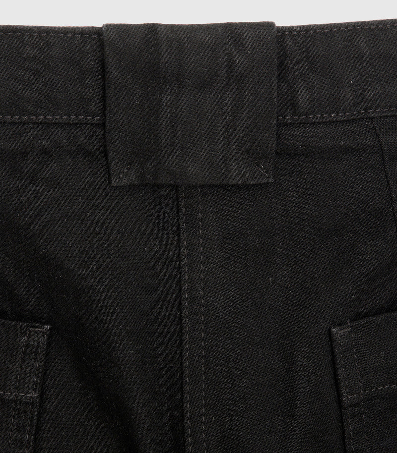 Close-up product view of the back waistband on a pair of black denim jeans, highlighting a wide, signature central belt loop, reinforced double-stitched back seam, and the tops of two rear patch pockets against a light grey background.