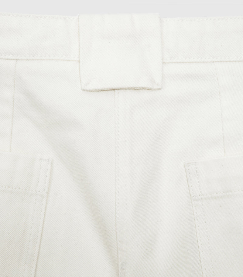 Close-up product view of the large middle belt loop and patch back pockets on the ecru wide-leg balloon jeans, showcasing the textured cotton twill denim fabric and tonal stitching, against a white background.