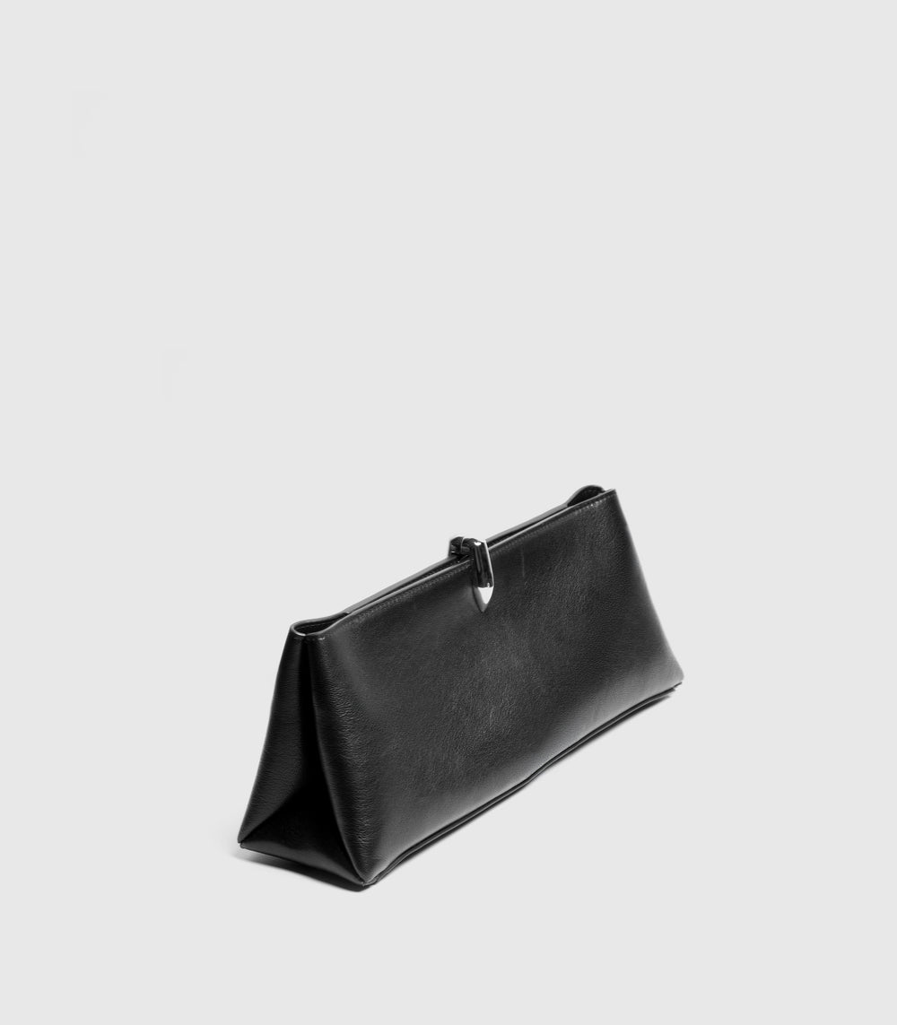 A black leather clutch bag with a triangular base and a small silver metal accent at the top, shown on a light gray background.