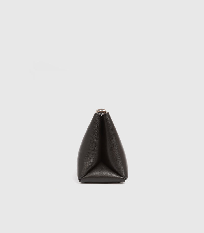 A black leather handbag with a unique pointed, diamond-like silhouette and a small silver-toned metal clasp at the top, shown against a plain light gray background.