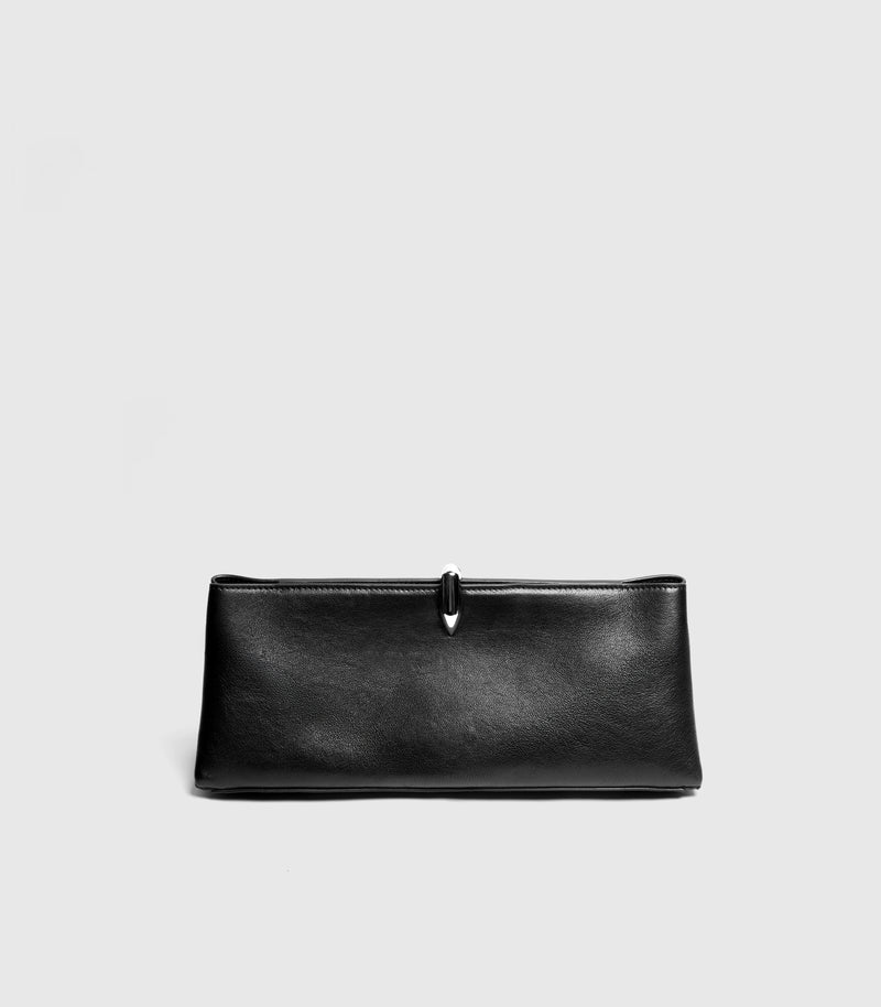 A black leather clutch bag with a small silver metal accent at the top center, shown against a light gray background.