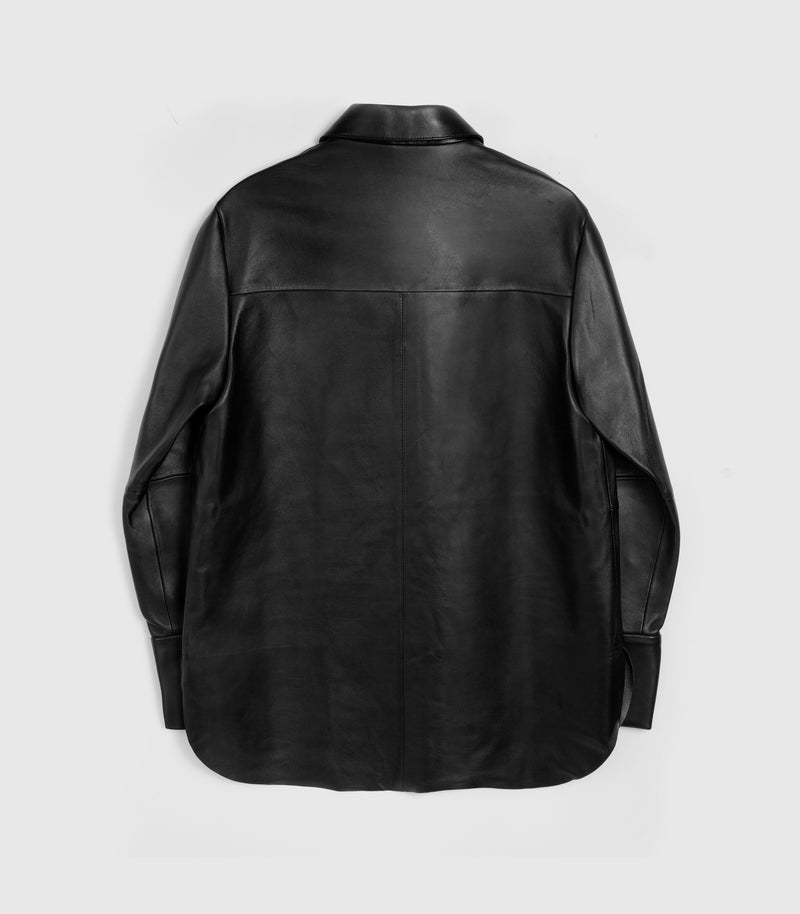 A black leather long-sleeve shirt jacket shown from the back, featuring a collar and a vertical seam down the center back, photographed against a light gray background.