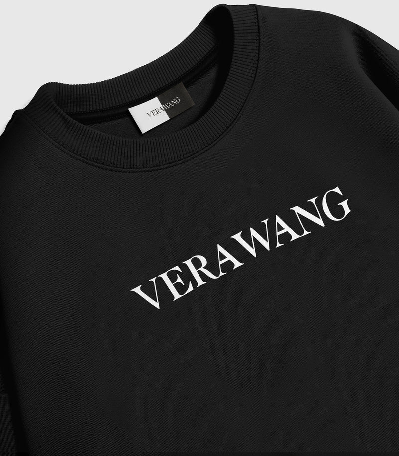 A black crewneck sweatshirt with 'VERA WANG' spell-out logo across the chest, against a white background.