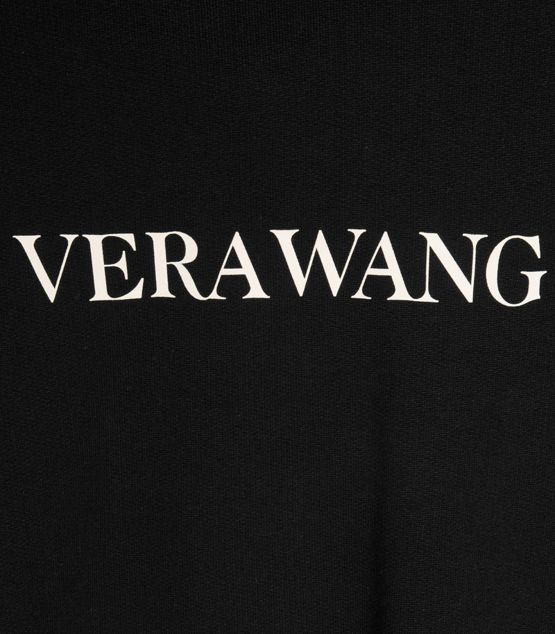 A detailed shot of the 'VERA WANG' spell-out logo across the chest.