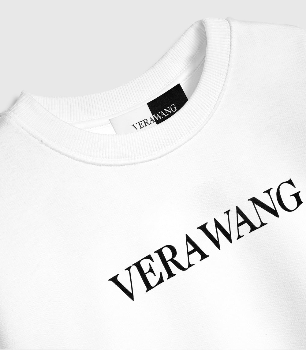 A white crewneck sweatshirt with a black 'VERA WANG' spell-out logo across the chest, against a white background.