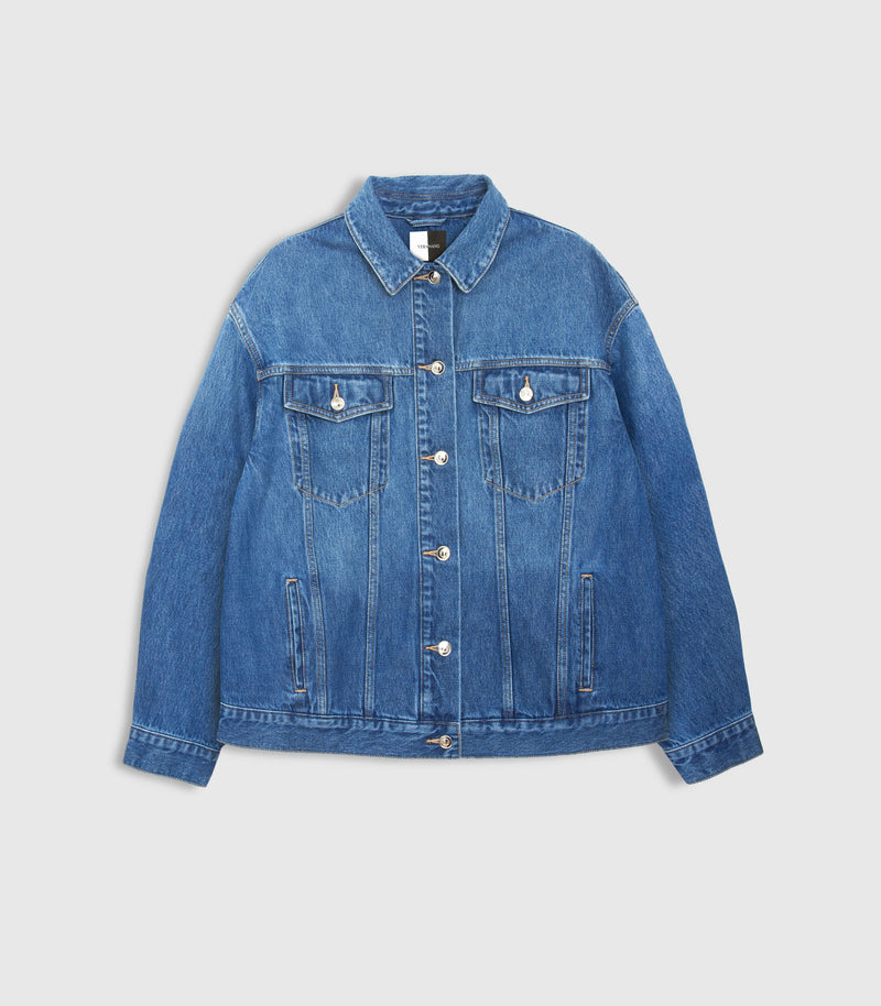 A classic blue denim jacket with a button-up front, two chest flap pockets, and two lower hand-warmer pockets, shown flat on a light gray background.