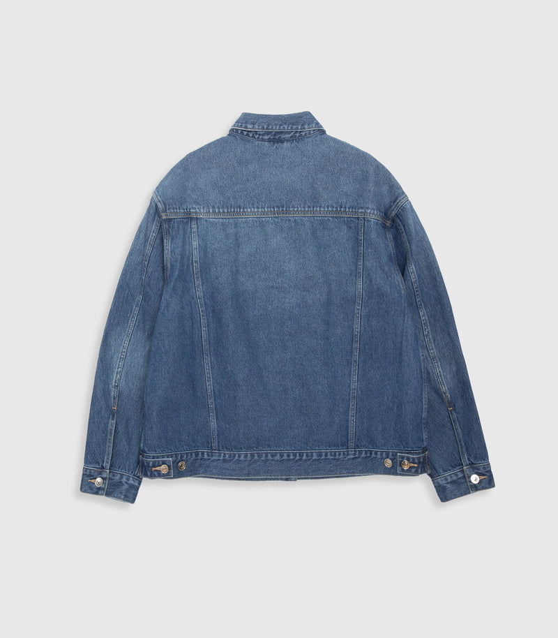 A blue denim jacket shown from the back, laid flat against a light gray background.