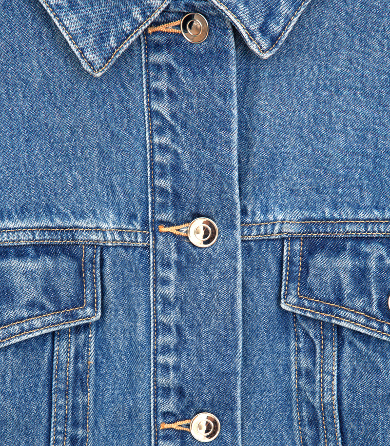 Close-up of a blue denim jacket showing the front button closure with silver metal buttons and contrast stitching.
