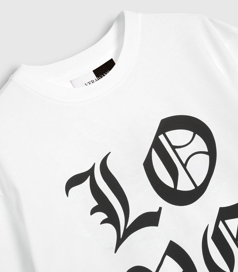 A closer shot of a white t-shirt with 'LOVE VERA WANG' spell-out logo across the front, against a white background.
