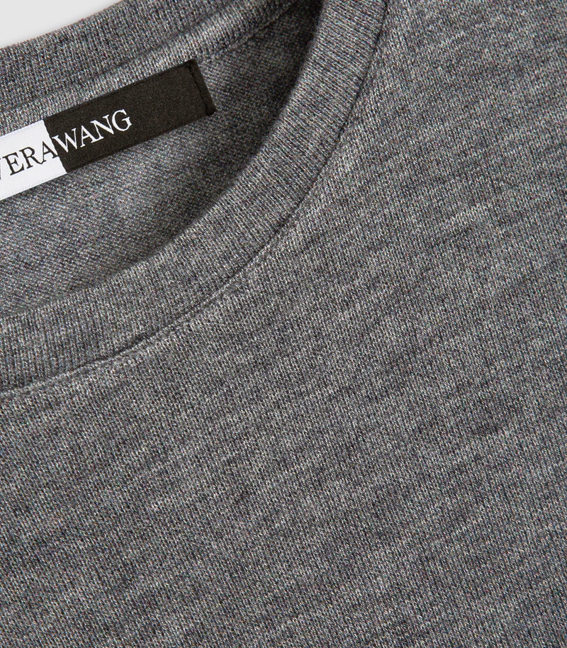 Close-up of a heather gray crewneck sweater with a black and white ERAWANG brand label visible inside the collar.