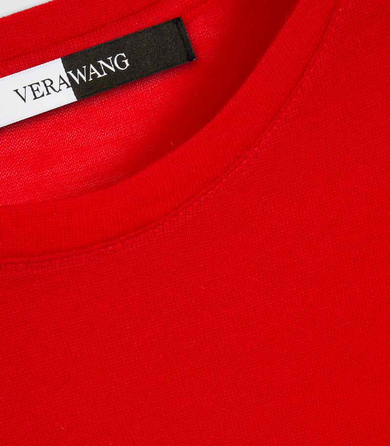 Close-up of a bright red crewneck garment with a visible VERAWANG neck label.
