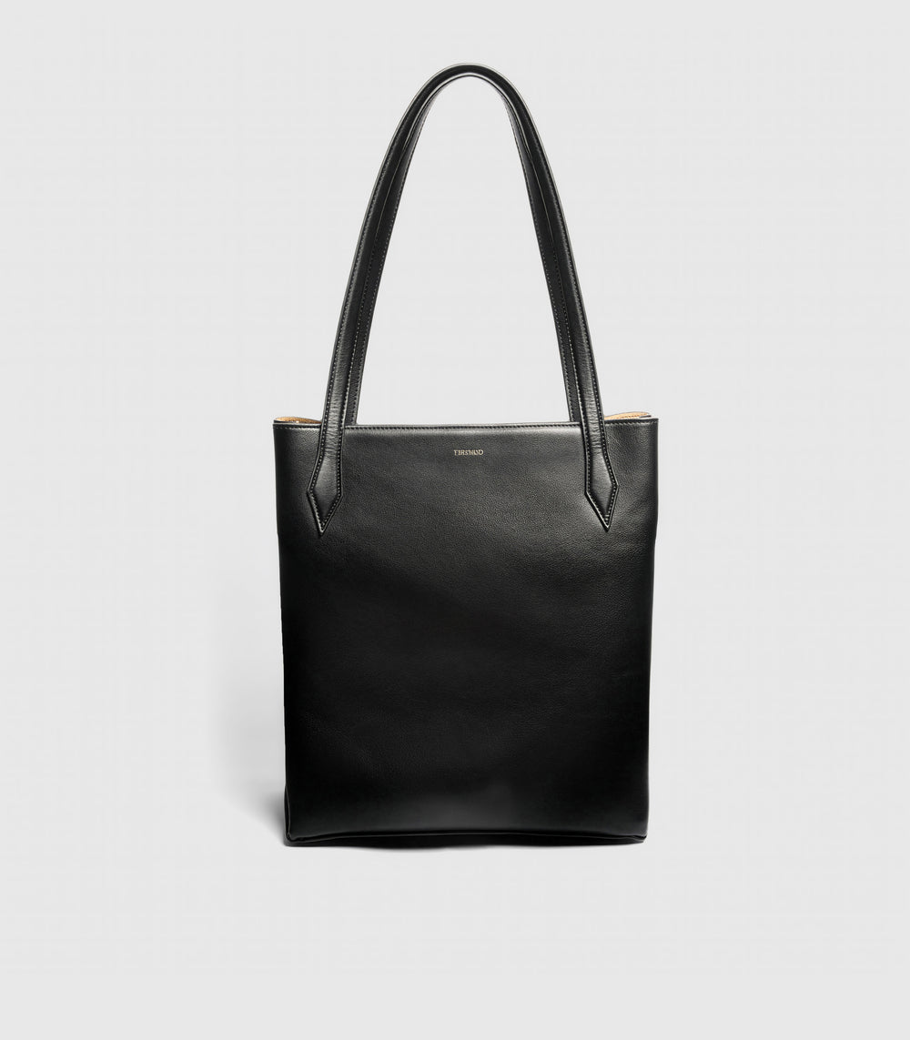 Black leather tote bag on a light gray background