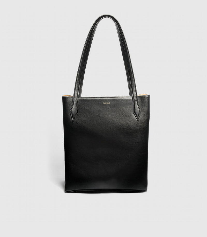 Black leather tote bag on a light gray background