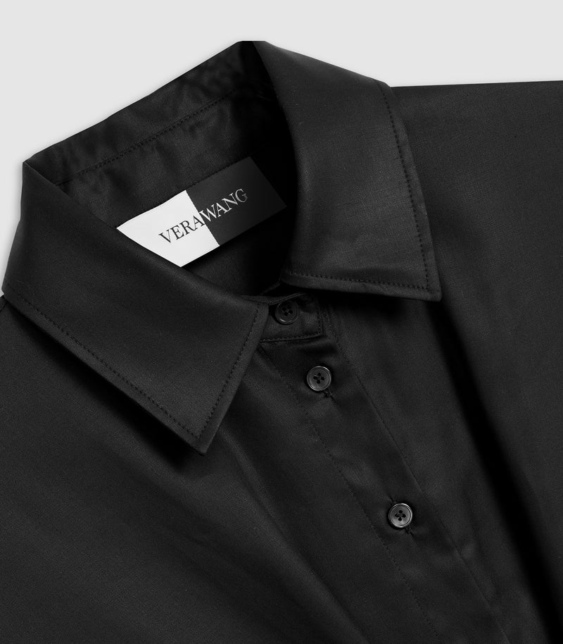 Close-up of a black button-down shirt collar with a visible neck label reading VERWANG, set against a light gray background.