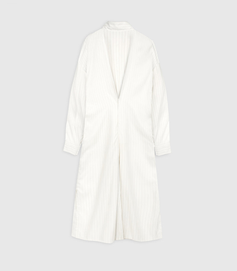 Flat lay rear product view of an ivory-beige midi shirt dress featuring a fine vertical pinstripe pattern. The design layout highlights a dramatic, deep V-shaped draped cowl back that meets at a central low waist seam. It shows a classic folded shirt collar, dropped shoulder seams, long sleeves with buttoned cuffs, and a straight midi skirt section against a seamless light grey backdrop.