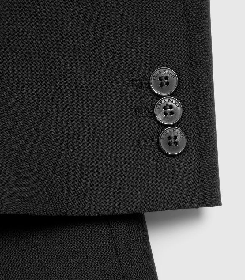 Close-up of a black suit jacket with buttons on a white background