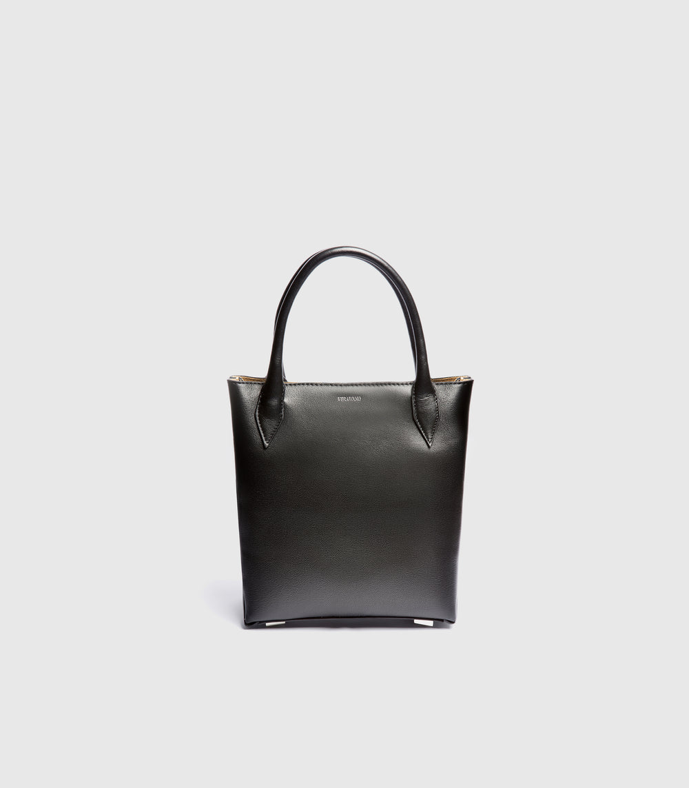 A black leather tote bag with double top handles, shown from the front against a light gray background.