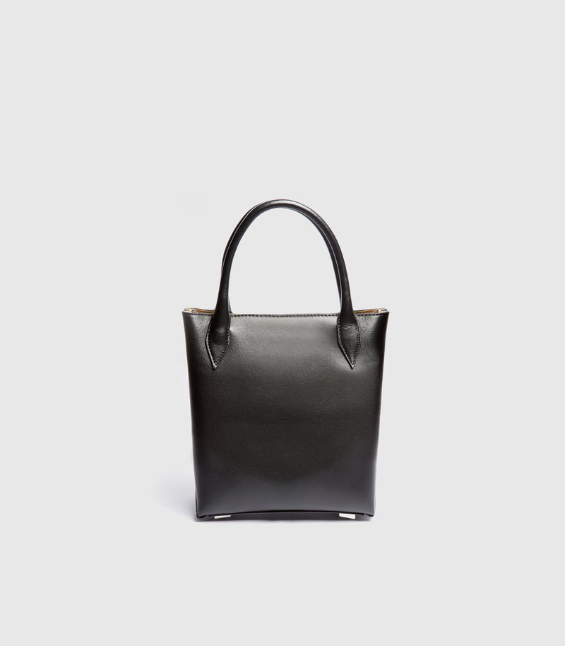A black leather top-handle tote bag with a structured rectangular silhouette, shown against a light gray background.