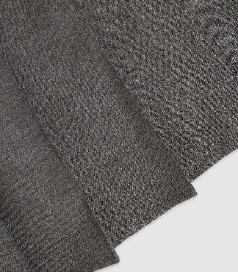 A close-up of dark gray heathered fabric with soft folds and a visible stitched edge, shown against a light neutral background.