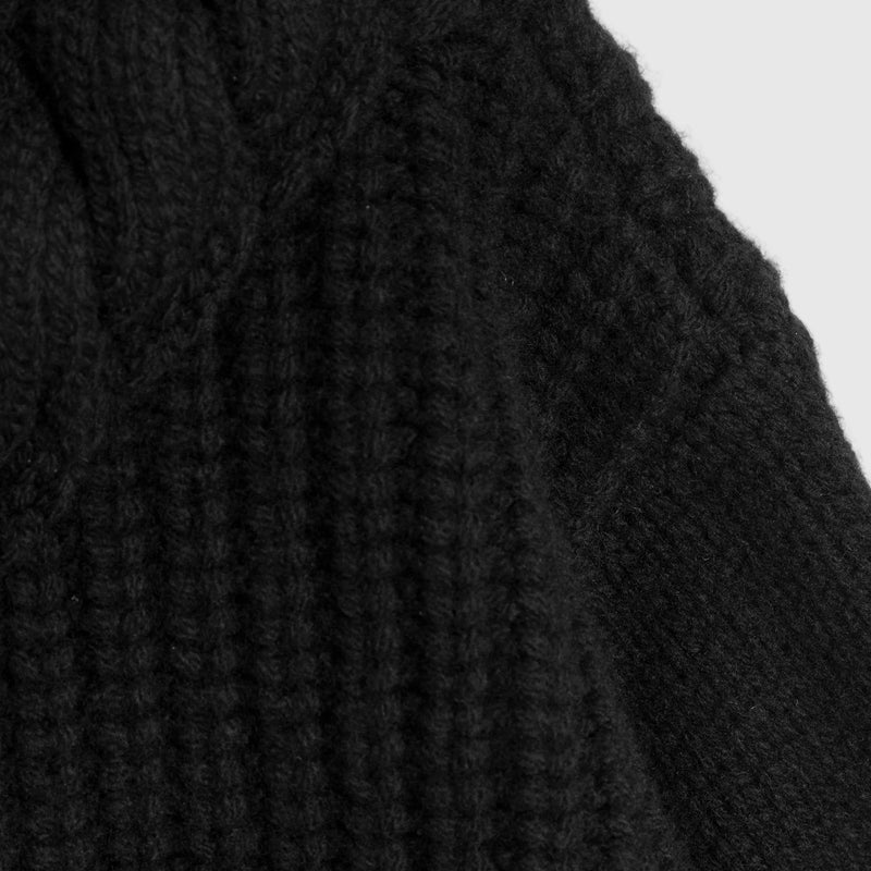 Close-up of a black fabric texture on a white background