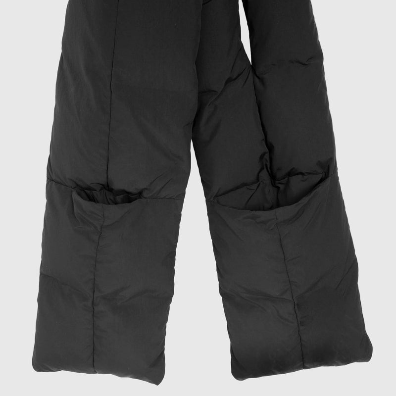Black puffer pants with quilted sections and large front pockets, laid flat on a white background.