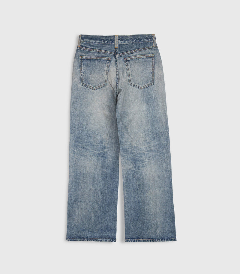 A pair of light blue denim jeans shown from the back, featuring a straight-to-wide leg fit and a heavily faded wash, photographed against a neutral light gray background.