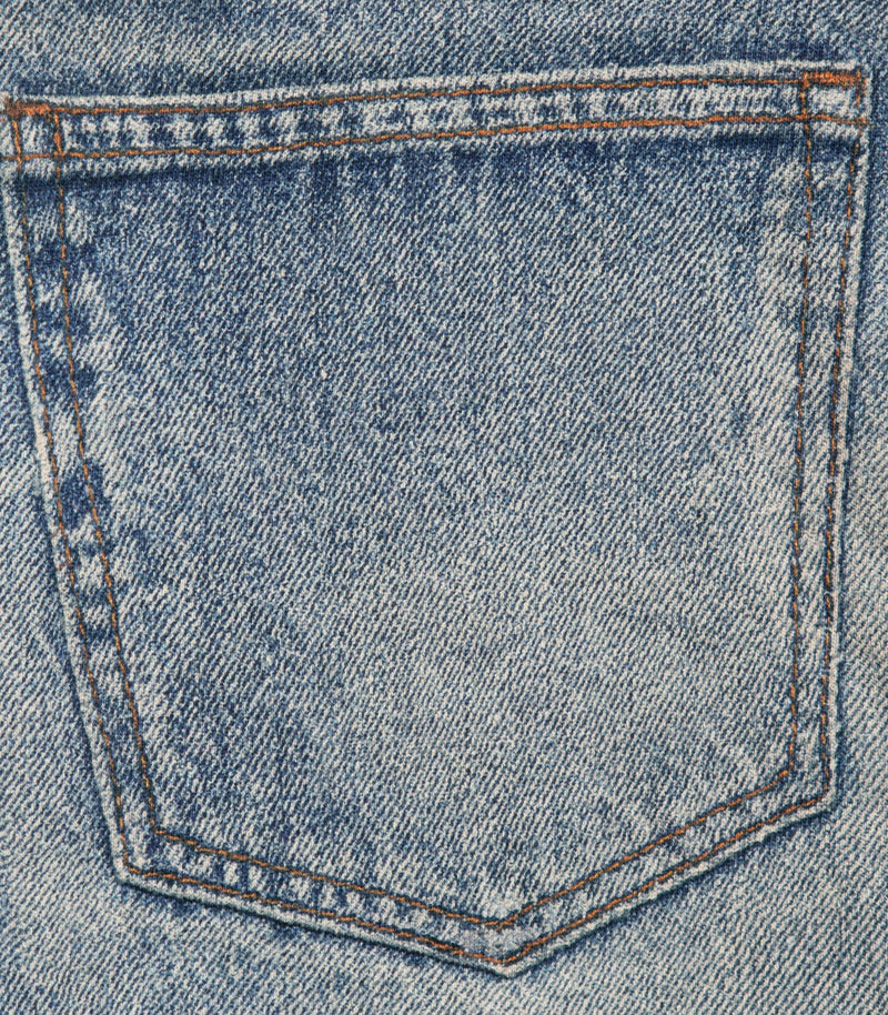 Close-up of a blue denim pocket with visible twill texture and double-stitched seam details.