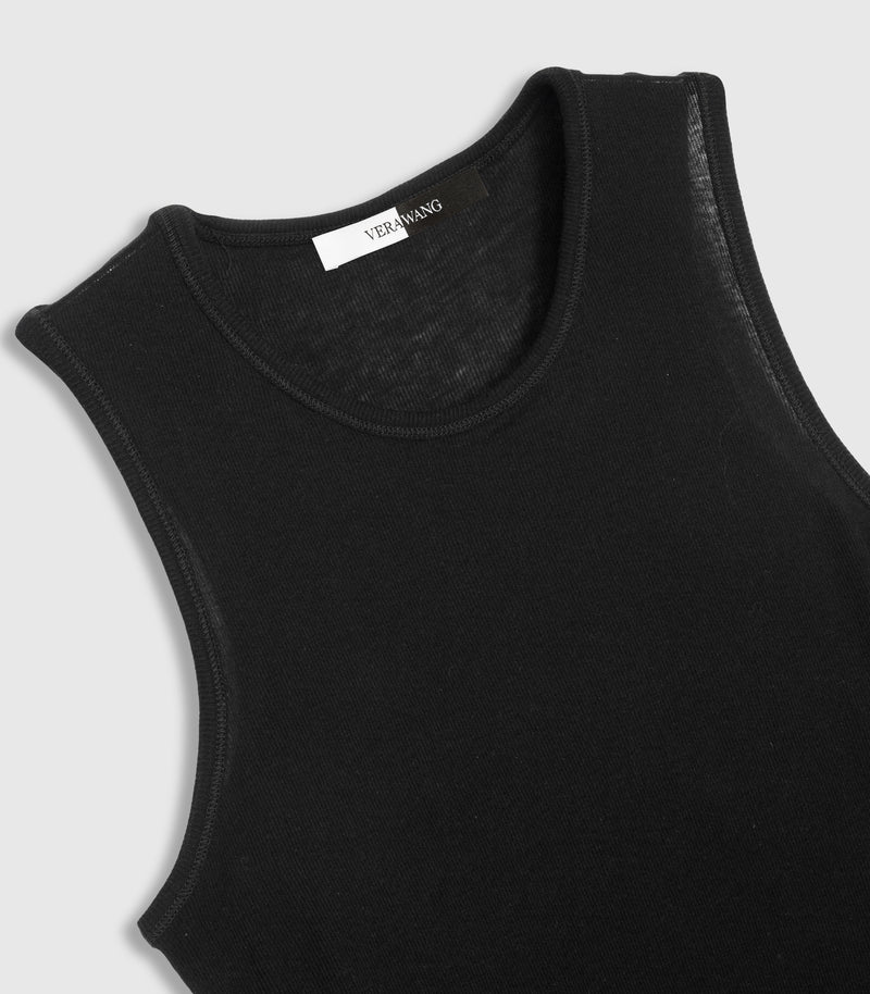 An angled, close-up product view of a black ribbed tank top, showcasing a high-cut crew neckline with precise tonal double-needle topstitching along the binding. The shot highlights the fine vertical ribbed knit texture, closely cut athletic armholes, and a split black-and-white inner neck brand label against a light grey background.