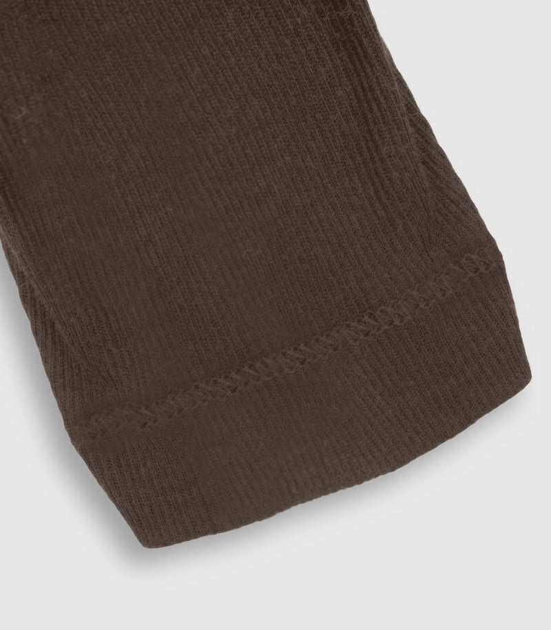 Close-up of a ribbed knit fabric cuff in dark brown, showing the texture and stitching detail against a light gray background.