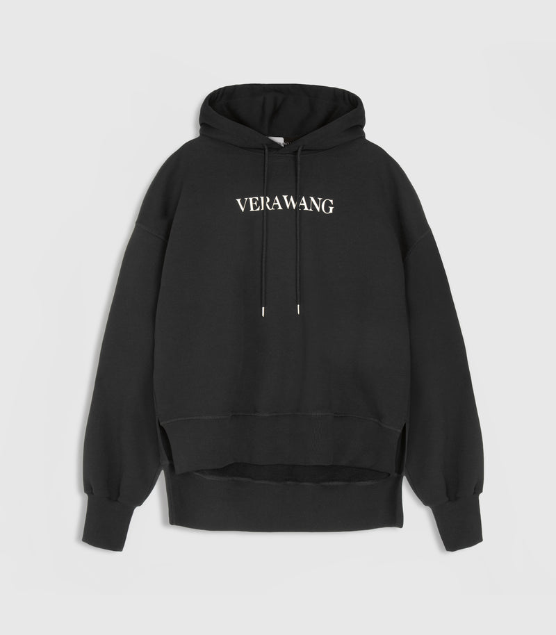 A black oversized hoodie with a white 'VERA WANG' spell-out logo across the chest, against a white background.