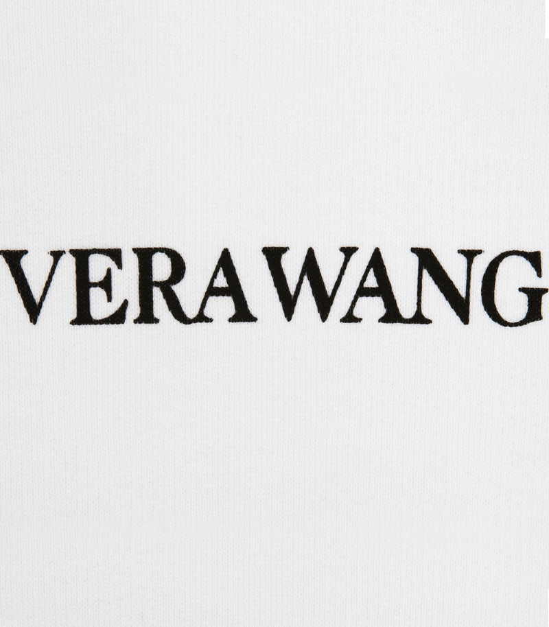 Close-up of a white fabric surface with the black embroidered text 'VERAWANG' across the center.
