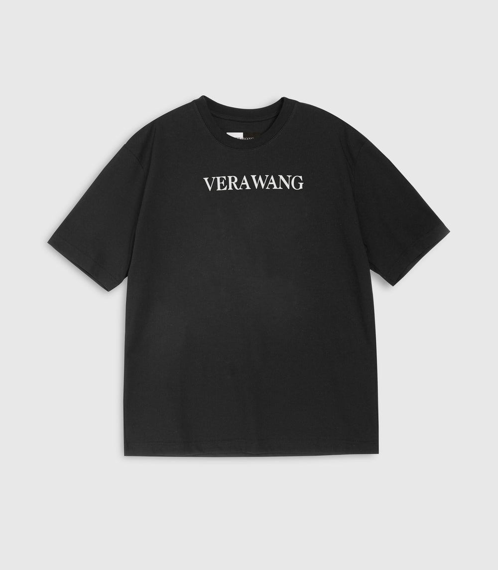 Flat lay view of a loose-fit black crewneck t-shirt featuring 'VERA WANG' logo in bold white text across the chest, displayed against a white background.
