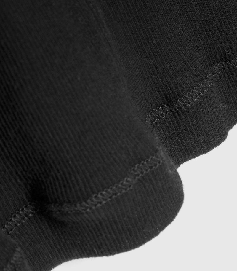 Displays the Sheer Black 'Vera Wang' branded long sleeve top featuring the close up on the details 