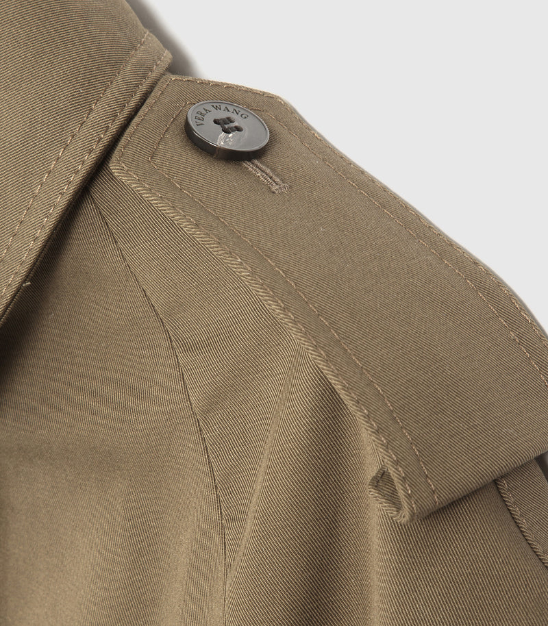Close-up of a khaki-colored jacket showing the collar, button closure, and detailed fabric stitching.