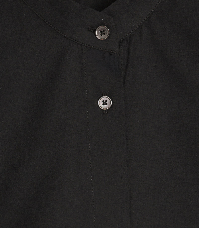 Close-up of a black button-up shirt showing the collar, front placket, and two black buttons.